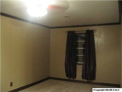Den with carpet, crown moulding & ceiling fan