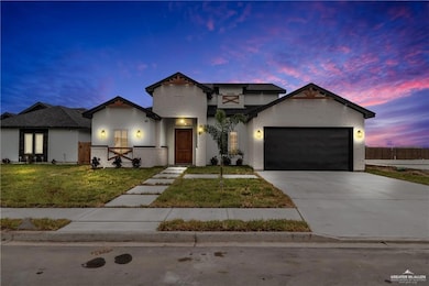 View of front of property featuring a yard and a garage