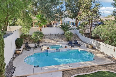 View of swimming pool featuring a patio area, a fenced backyard, and a pool with connected hot tub