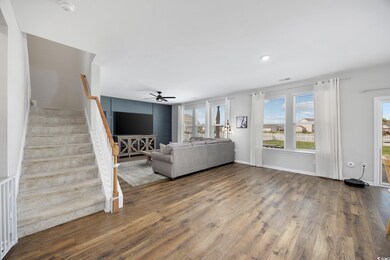 Unfurnished living room featuring ceiling fan and 