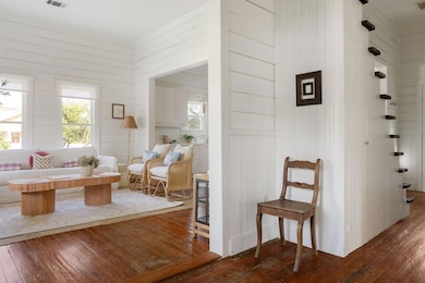Hallway with wood-type flooring, plenty of natura