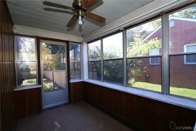 Sunroom has 8 windows, pine paneling and opens to back stoop and the back yard.