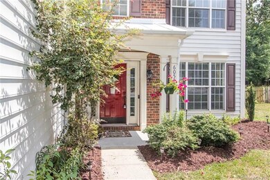 Beautiful landscaping leads to the welcoming red f