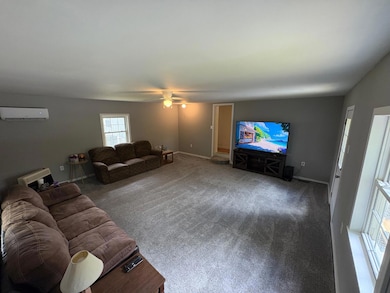 Living room is awesome size with tons of space and furnished as well as Tv and stand that is seen here.