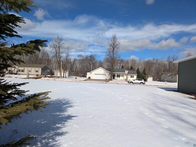 Yard layered in snow with a garage