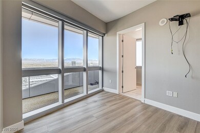 Empty room featuring baseboards, a mountain view,