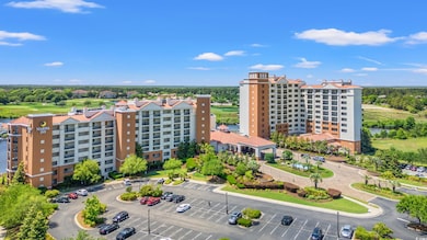 Drone / aerial view of apartment complex and a nearby body of water