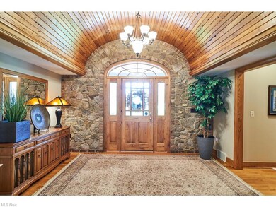 The large  foyer has a barrel ceiling and hardwood floors welcomes your guests into this magnificent home.