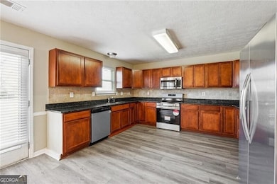 Kitchen featuring light wood-style floors, applian