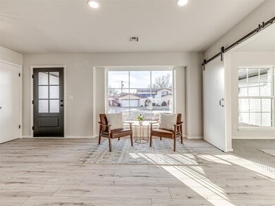 Entryway featuring a barn door and light wood-type