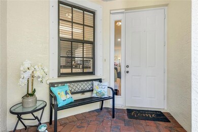 Entrance to property with stucco siding and a patio