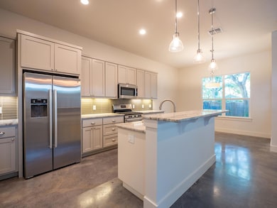 Kitchen featuring appliances with stainless steel