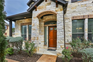 Doorway to property with stone siding