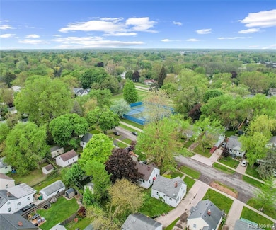 Aerial perspective of suburban area featuring a heavily wooded area