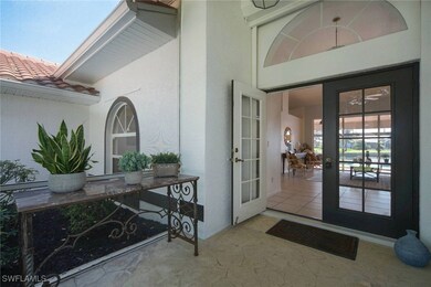 View of exterior entry with French doors, a tile r