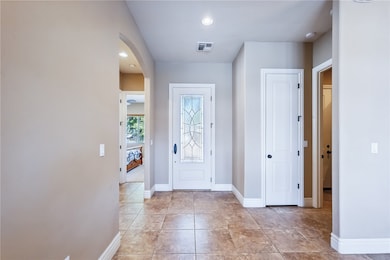 Entryway with arched walkways and recessed lightin