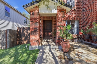 Doorway to property featuring brick siding