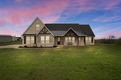 View of front facade with a yard and a porch