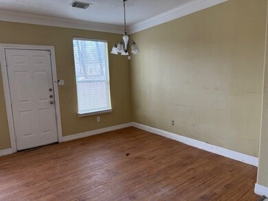 Dining room features laminate-wood flooring with a