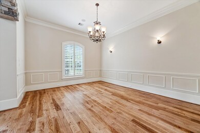 Hardwood floors stretch across the dining room, wh