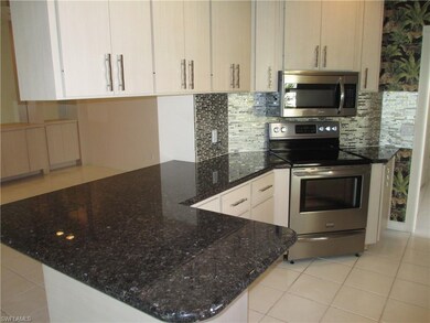 Kitchen granite and newer backsplash.