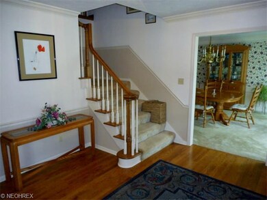 The foyer of this home has oak wood floors and a n