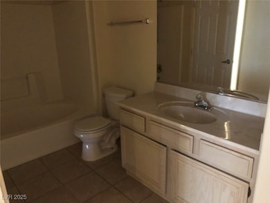 Bathroom featuring tile patterned floors, toilet,