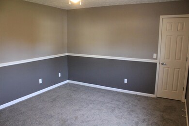 shot of master bedroom that has new carpet new paint and bathroom has new vanity and paint as well