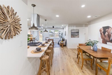 Kitchen with decorative light fixtures, ceiling fa