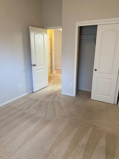 Unfurnished bedroom with carpet flooring, arched 