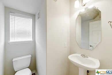 Your powder room features a pedestal sink, tile fl