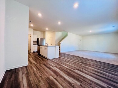 Unfurnished living room with baseboards, dark wood