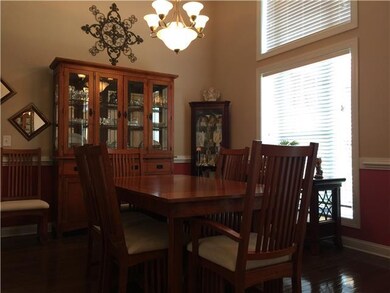 Formal dining area with soaring ceiling and window