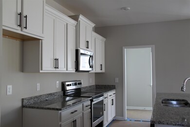 View of the kitchen leading to the laundry room in a similar house.  Appliances not yet installed.