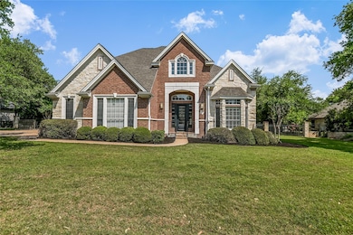 Craftsman-style home with brick siding, fence, st