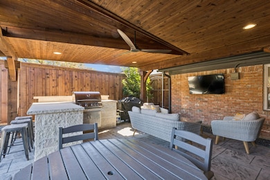 Fully covered patio with recessed lighting and a fan, stamped concrete, built in grill, outdoor refrigerator
