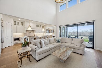 Living area with recessed lighting, a chandelier, 