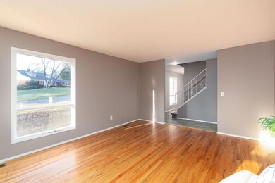 Large Living Room with Light and Bright Window! Hardwood Flooring throughout most of the home and a peek at the New Vinyl Plank Floors in the Large Entry. Fresh and Modern Newly Painted Interior!