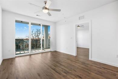Empty room with dark wood-type flooring and ceiling fan