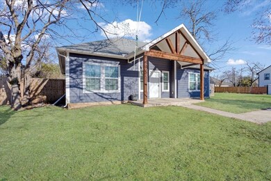 View of front of property featuring a fenced backyard, a front lawn, and roof with shingles