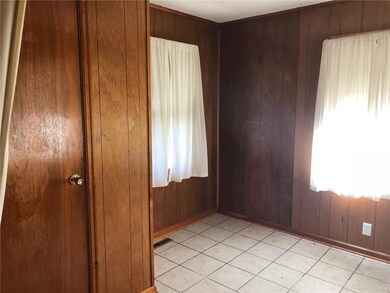 Den has tile floor and plenty of light.