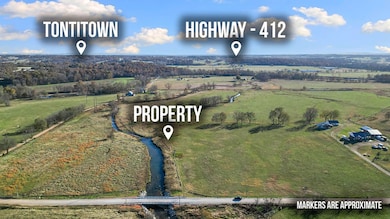 This tract is to the right of the property marker shown here. this tract doesn't touch the creek.