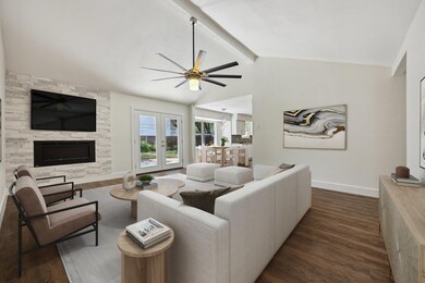 Living room featuring dark wood-style flooring, c