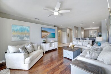 Living room featuring rich hardwood floors and lig