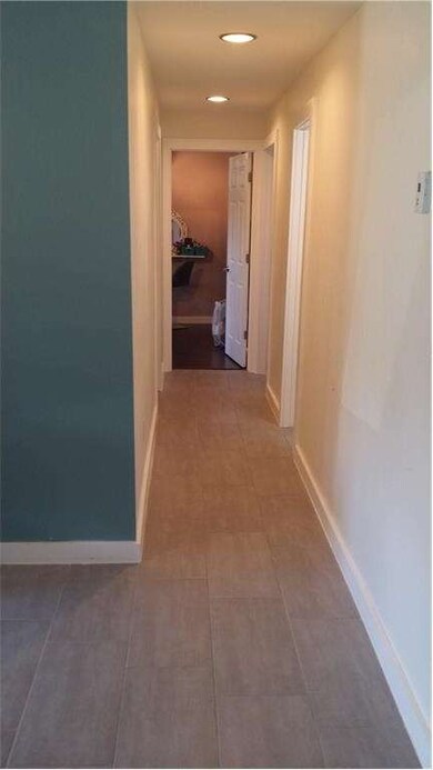 Hallway to 3 bedrooms and Bathroom. New rectangula