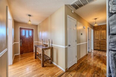 Foyer featuring light wood-style flooring and a textured ceiling