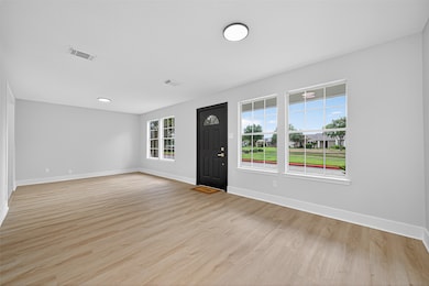 Greeted by a wide dining/living combo.