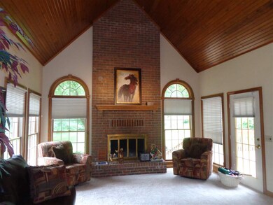 The two story great room has a wood ceiling, full 
