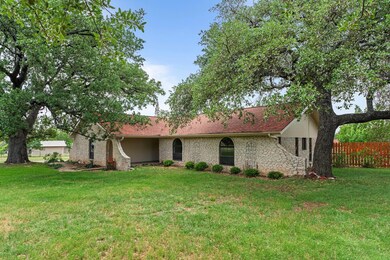 Ranch-style house with a front yard, fence, and s