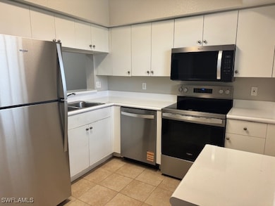 Kitchen with stainless steel appliances, light cou